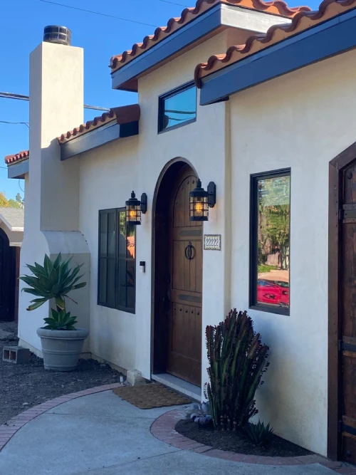 Modern house with expansive glass walls overlooking a patio and garden