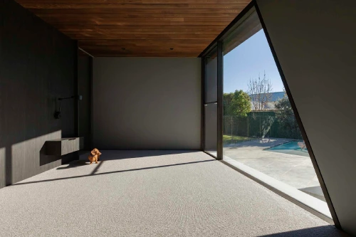 Interior view of a modern living space with floor-to-ceiling glass doors